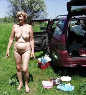 GILF standing next to a car