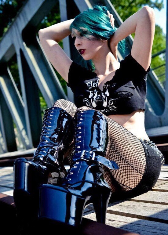 Punk / goth chick in fishnets and high heel boots