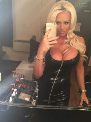 Hot blonde with nice tits in a black latex dress selfie