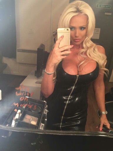 Hot blonde with nice tits in a black latex dress selfie