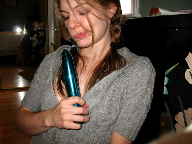 Hot brunette babe playing with a blue dildo