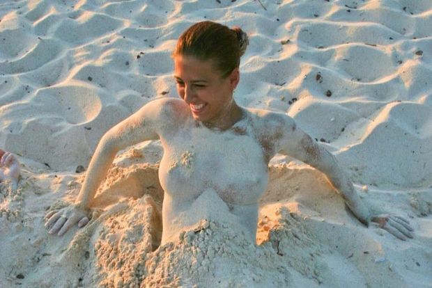 Fit Latina chick topless on white sand beach