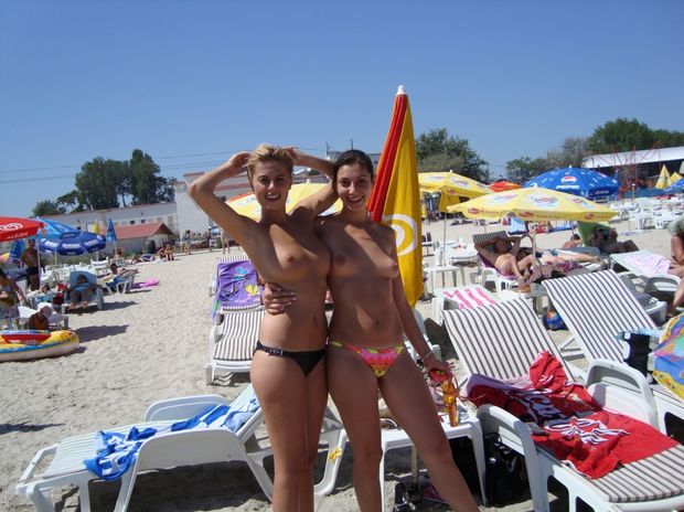 Sexy blonde Romanian babe having topless fun at the beach