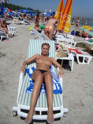 Sexy blonde Romanian babe having topless fun at the beach