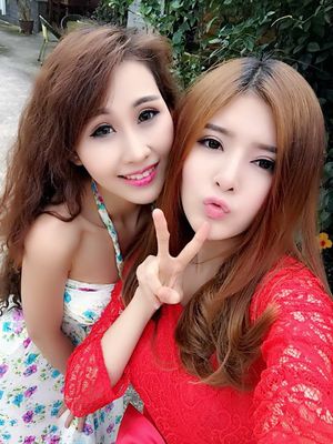 Two Vietnamese 19 Year Old Spinner Beauties Blowing A Kiss With Their Pink Lips