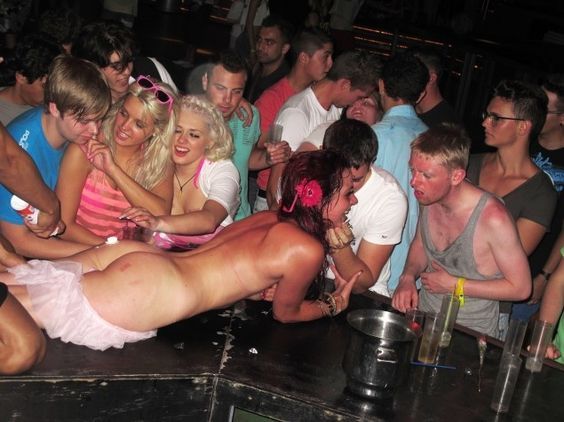 Nude on the piano at a party.