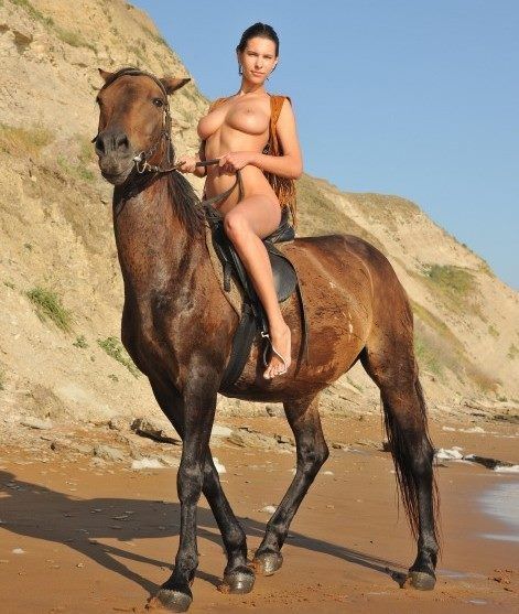 Brunette riding a horse.