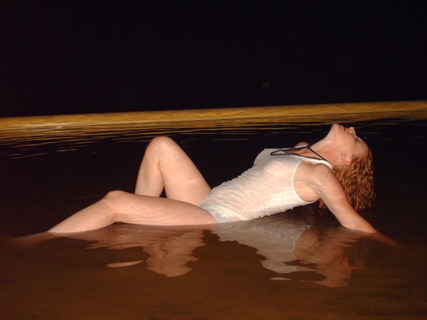 Cute Redhead taking a bath in dirty water