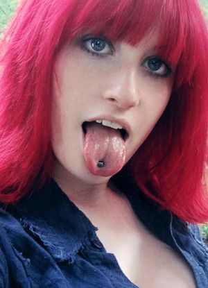 Red haired emo cock tease showing off her tongue.