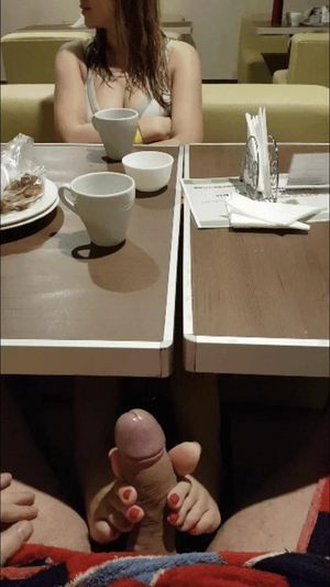 Footjob in restaurant