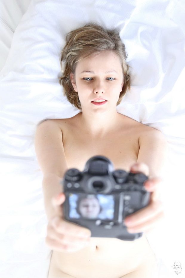 Blond photographer takes a selfshot with dslr