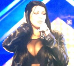 Micky Syndrome is star singer who sings her song in a skimpy see though top that shows her cleavage - fota 911