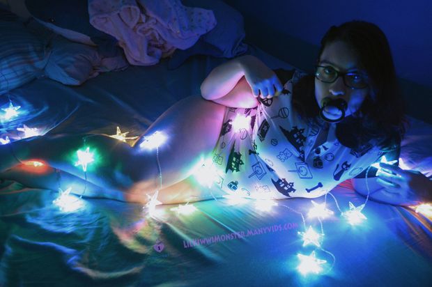 LilKiwwiMonster cuddles with Brucie the Shark and her sparkly lights