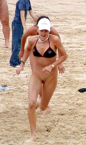 Bottomless babe running on beach