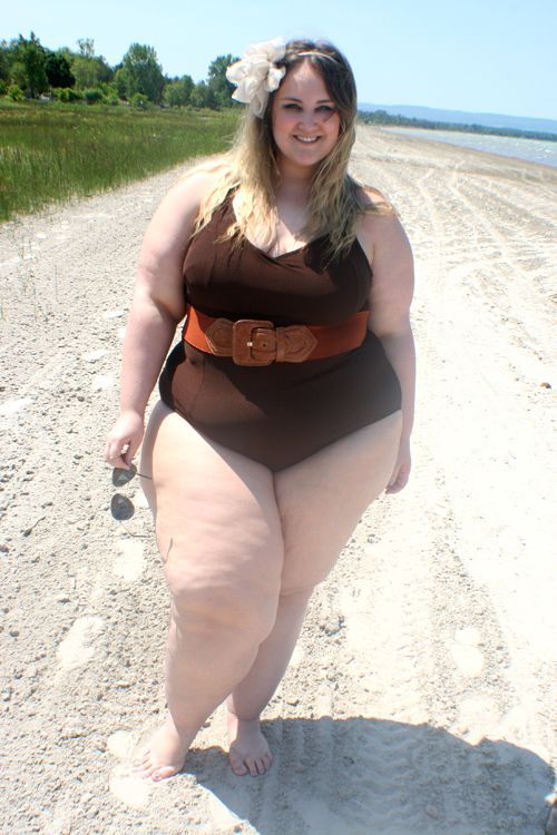 Big legs in swimsuit on the beach