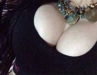 She has almost a boa of necklaces around her neck - SGBb