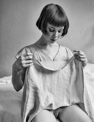 Woman with no pants on and shaved pussy showing