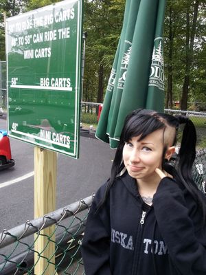 Paraquat Suicide makes a sexy goth facial expression while right outside by the go carts with awesome gothic black hair- SGB cooll gothh hff