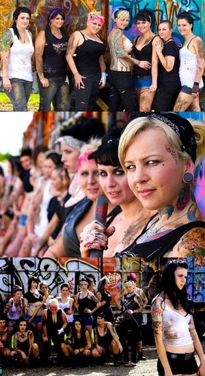 Bomby Blondshell taking a group shot outside of Aniston Playhouse with spray paint & emo alt models groups - SGB cooll gothh