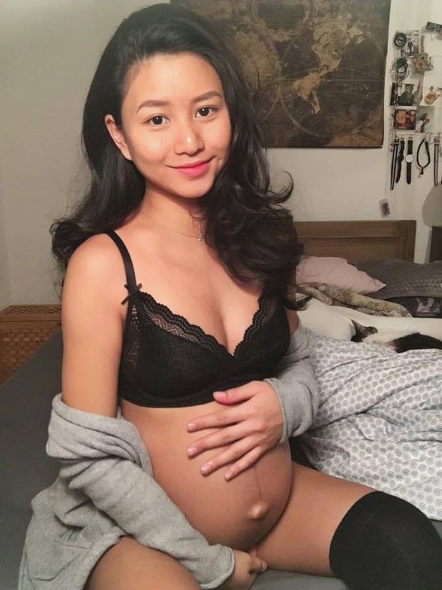 Pregnant Asian in black bra and stockings