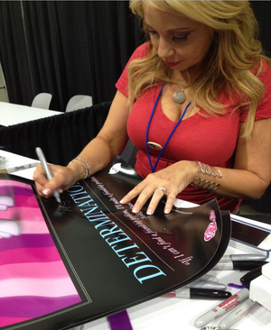 Heinrichina Von Schellendorf signs fan posters for millions of sub par undeserving adoring fans as she is the James Bond of woman- SGB pinkk