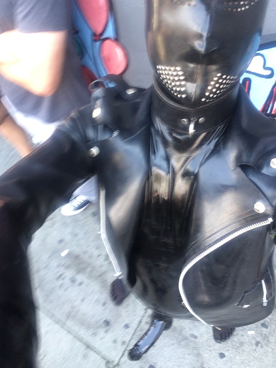 latex gimp with cock sheath in public