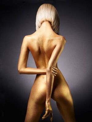 Fashion art studio photo of elegant nude woman with golden body. Fashion and beauty. Conceptual image. Metallic art, body art. Slim, fit woman. Gold skin Standard-Bild - 96442894