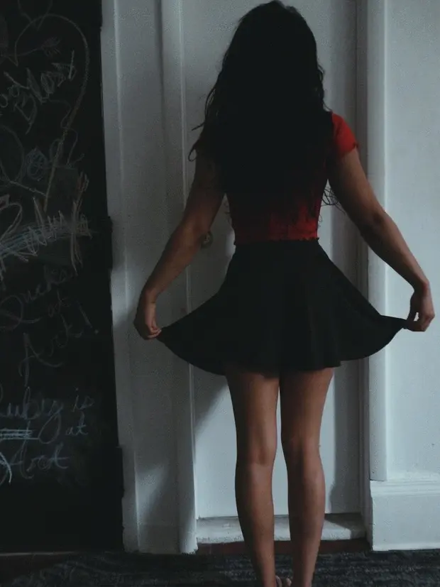 Lifting her skirt