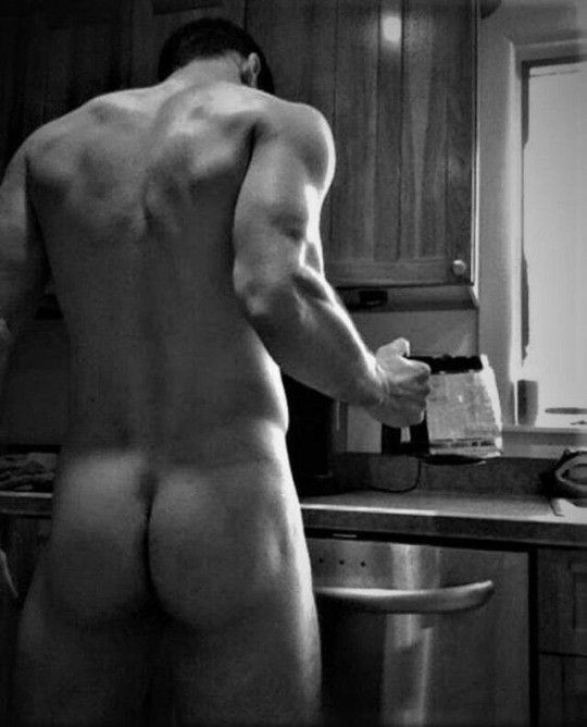 Nude male making coffee