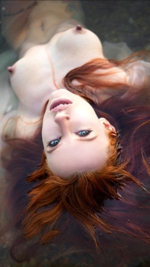 Beautiful redhead in pool