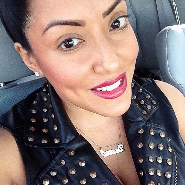 Moon Fish is a rad non-white woman in a stylish badass cool spiked studded sleeveless black leather vest with studs - SGB cooll lett