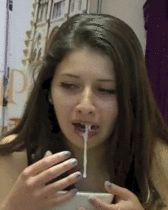 Cute brunette eating... something...