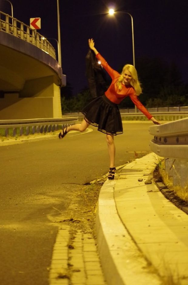 Leggy blonde in sheer top and miniskirt posing outdoors