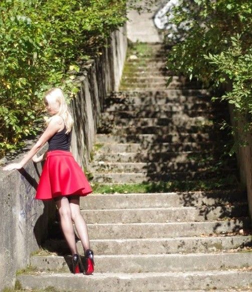 Blonde insta chick posing outdoors in red miniskirt nylons and heels