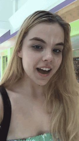Adorable teen walking through a mall after taking a load of cum on her face.