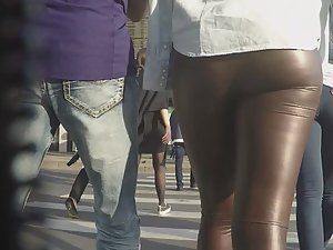 sexy woman in brown shiny leggings