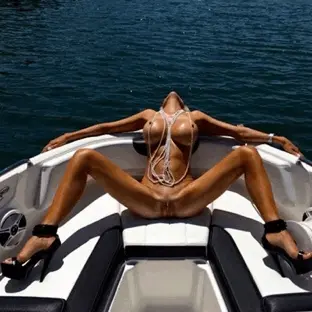 Tanned bimbo lounging on a boat