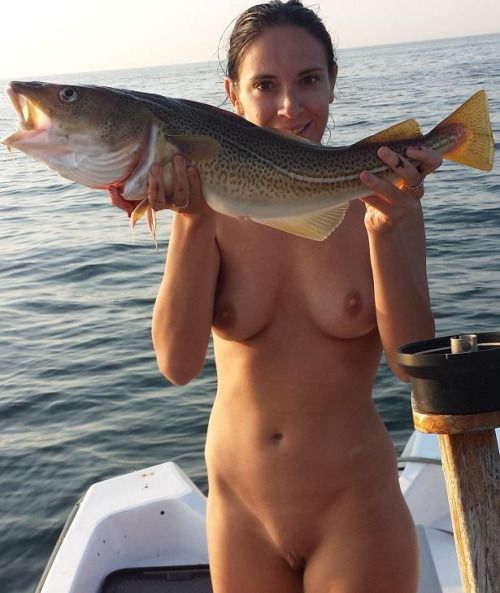 Proud of the fish she caught while nude.