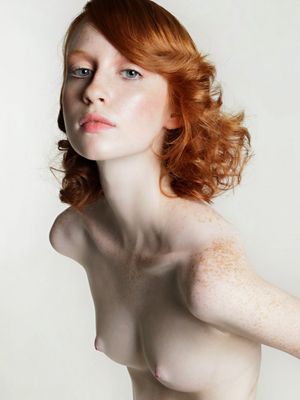 Pale redhead topless