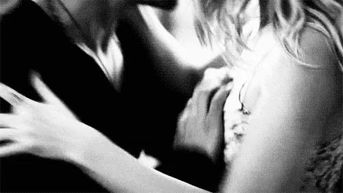 man removes woman's top and they kiss