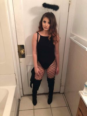 cute brunette in knee high high heel boots and fishnet stockings and leotard