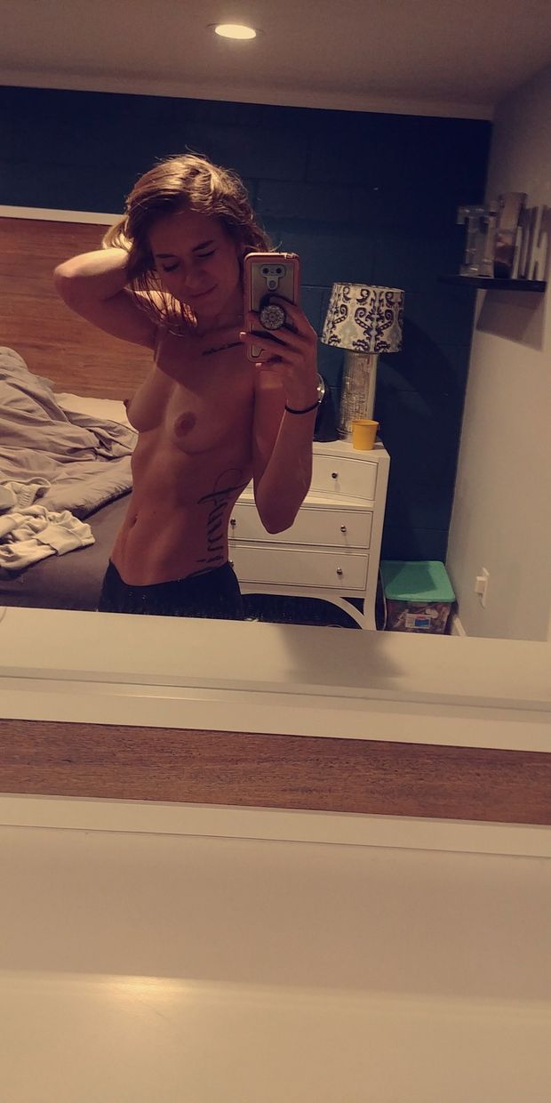 cute fit athletic brunette taking topless selfie