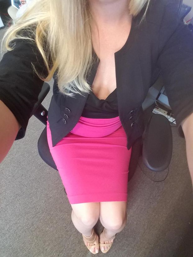 office blonde in low cut blouse and skirt