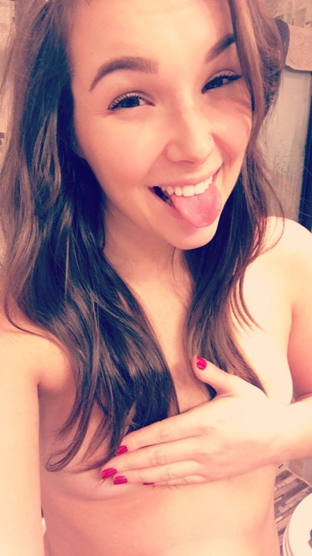 cute brunette sticking her tongue out topless hand bra selfie