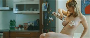 gif - naked in kitchen putting whipped cream on her tits