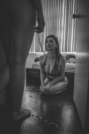 sexy sub with big boobs in bra on her knees on a leash and collar