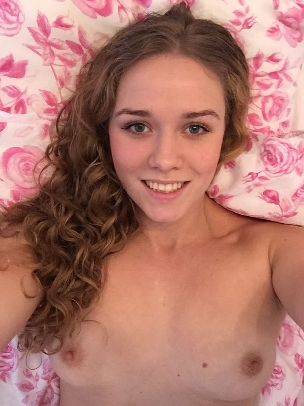 cute brunette topless selfie in bed with small tits