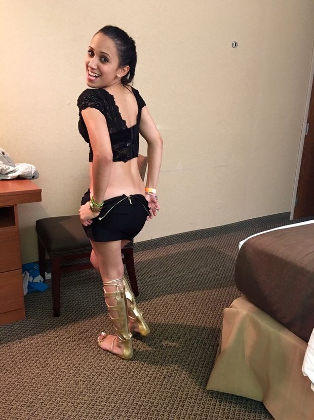 cute smiling brunette stripping in hotel room with small tits
