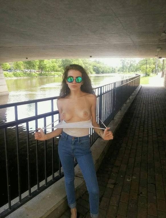 brunette in jeans flashing her tits outside in public