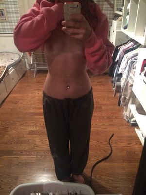 in sweatpants and sweatshirt flashing her tits